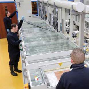 Workers inspect metal during the chemical milling process